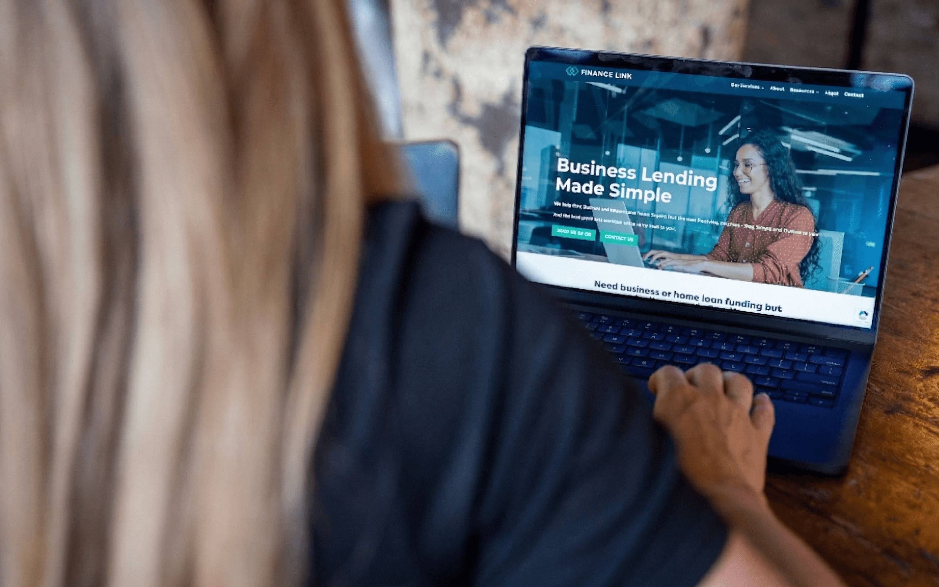 Business owner reviewing lending options on laptop